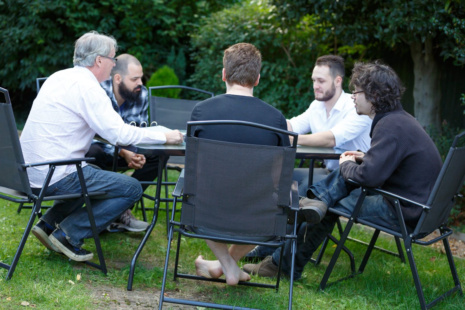 People talking at a garden table
