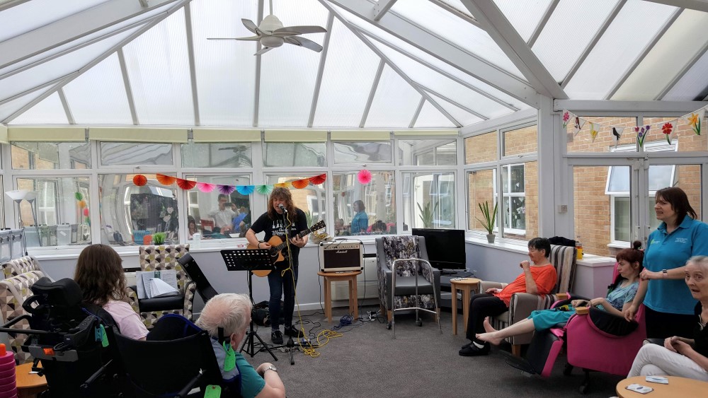 People listening to a musician in a conservatory