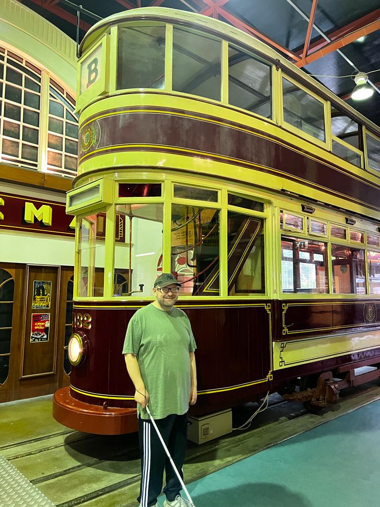 Person in front of an old fashioned tram