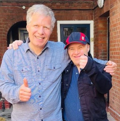 Two people with thumbs up