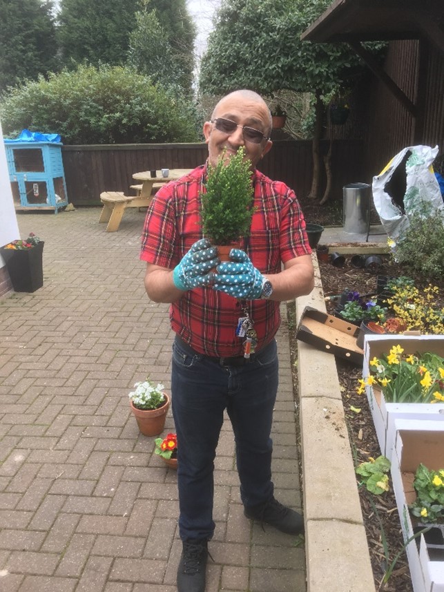Person holding plant