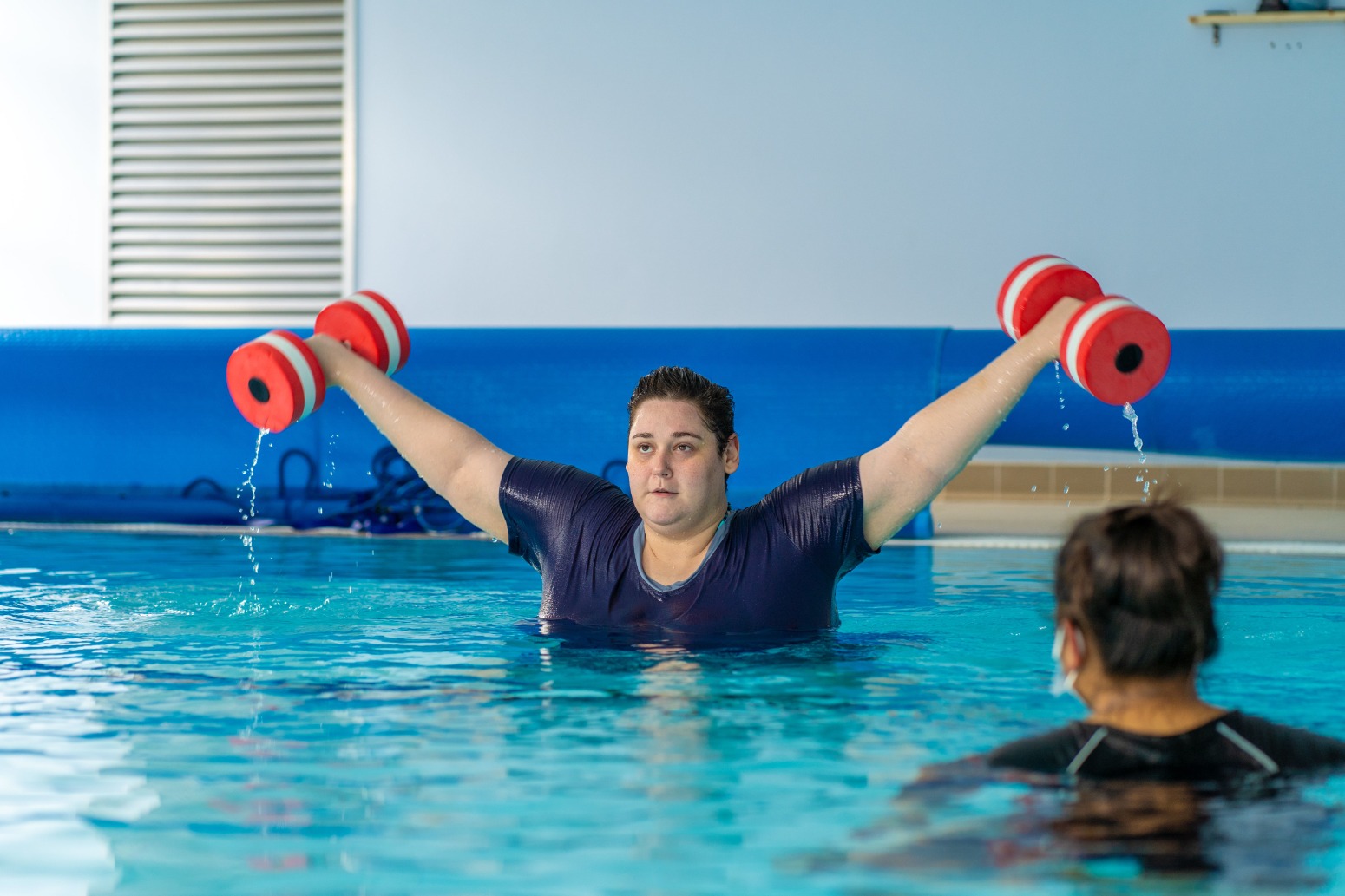 Person holding floats swimming