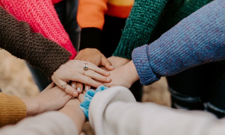 support worker hands together in a group